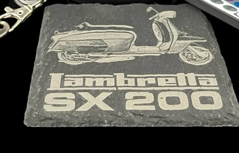Natural slate coaster with an engraved scooter design